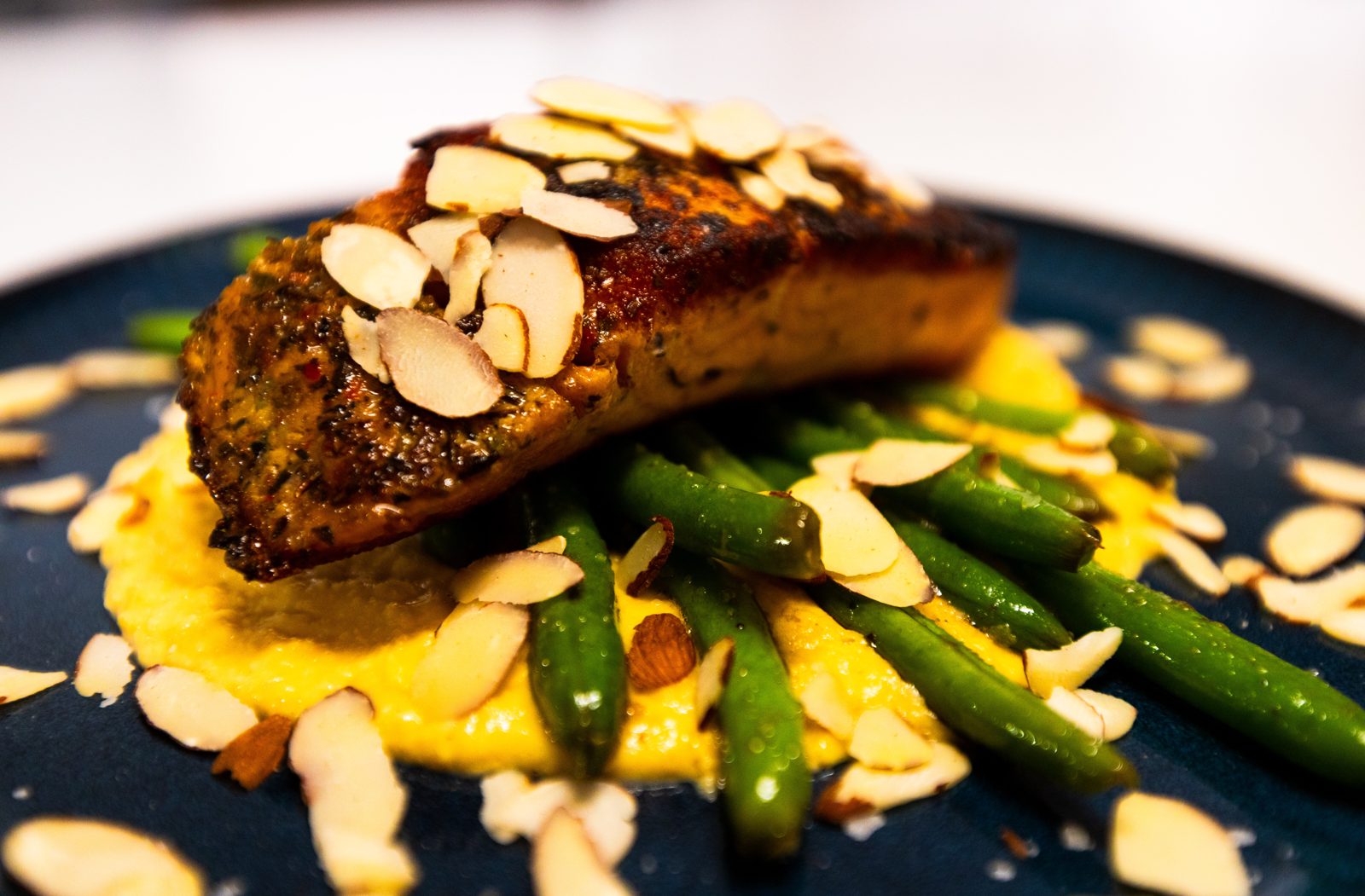 Almond-crusted salmon over squash purée with green beans